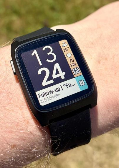 Smartwatch displaying time 13:24, weather, heart rate, date, and a notification to follow-up in 6 minutes.